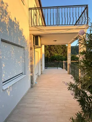 a walkway leading up to a building with a balcony at Vila Dusan in Bar