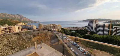 an aerial view of a city with cars parked at Penthouse Traumblick Bečići in Budva