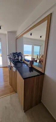 a bathroom with a counter with a mirror and a sink at Penthouse Traumblick Bečići in Budva