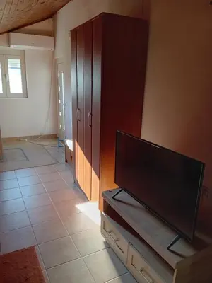 a living room with a flat screen tv on a cabinet at REX aprartament in Podgorica