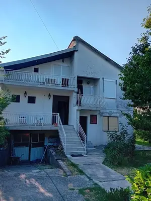 an old white building with stairs and a porch at REX aprartament in Podgorica
