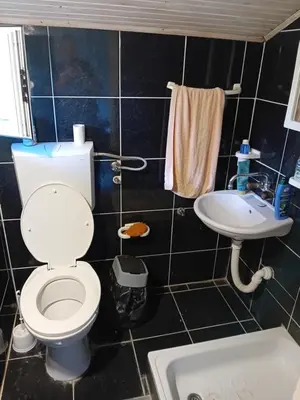 a bathroom with a toilet and a sink at REX aprartament in Podgorica