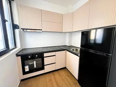 a kitchen with a black refrigerator and a sink at Florida Apartments in Dobra Voda