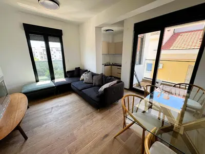 a living room with a couch and a table at Florida Apartments in Dobra Voda