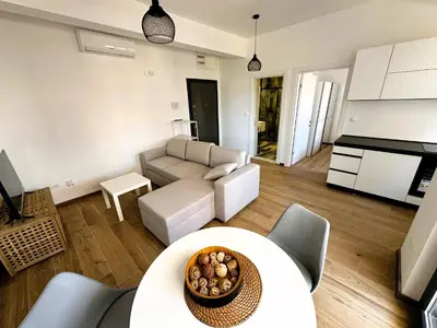 a living room with a couch and a table at Florida Apartments in Dobra Voda