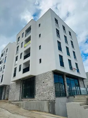 a large white building with windows at Florida Apartments in Dobra Voda