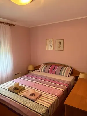 a bedroom with a bed with two towels on it at Njaro Del Mar 14 in Petrovac na Moru