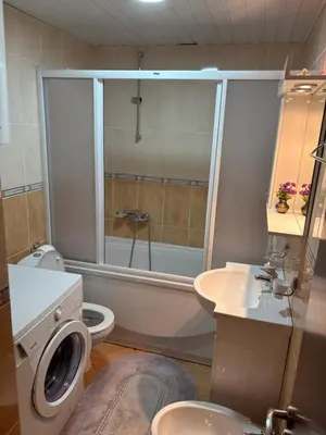 a bathroom with a toilet a sink and a shower at Njaro Del Mar 14 in Petrovac na Moru