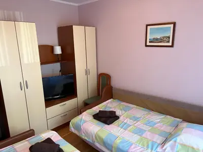 a bedroom with a bed and a flat screen tv at Njaro Del Mar 14 in Petrovac na Moru