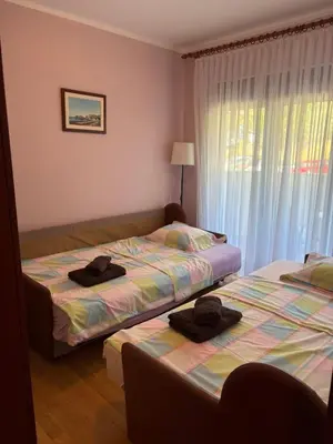 two beds in a bedroom with two hats on them at Njaro Del Mar 14 in Petrovac na Moru