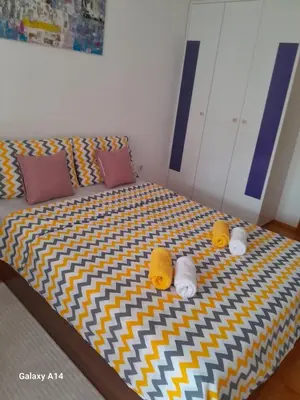 a bed with two stuffed animals on top of it at Apartman Ana in Budva