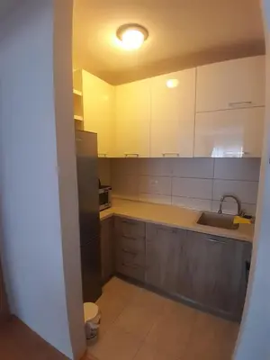 a kitchen with white cabinets and a sink at Apartman Ana in Budva