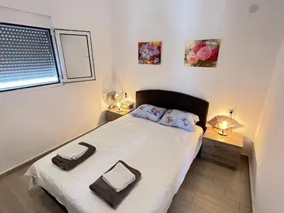 a small bedroom with a bed and a window at Second floor near the Long Beach, Montenegro in Ulcinj