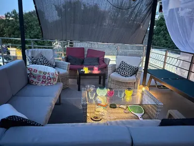 a patio with a couch and chairs and a table at Second floor near the Long Beach, Montenegro in Ulcinj