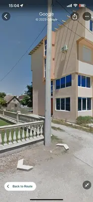 a building with a pole in front of a building at Second floor near the Long Beach, Montenegro in Ulcinj