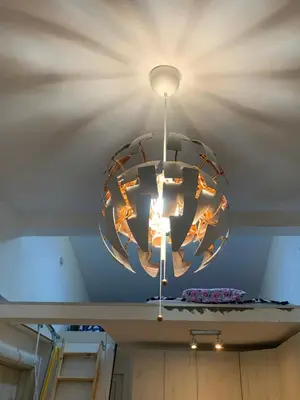 a chandelier hanging from a ceiling in a room at Second floor near the Long Beach, Montenegro in Ulcinj