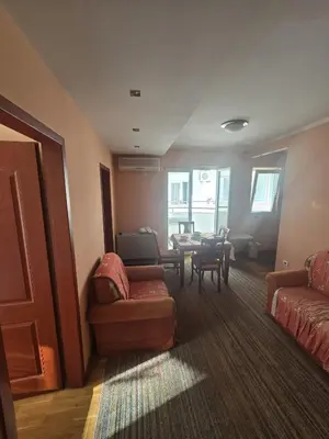 a living room with a couch and a table at Apartman Orange Budva in Budva