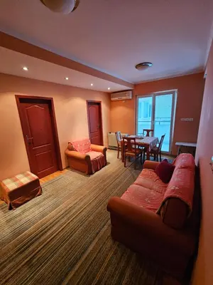 a living room with a couch and a table at Apartman Orange Budva in Budva