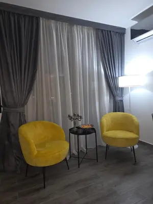two yellow chairs and a table in front of a window at Villa Azzurra in Radanovići