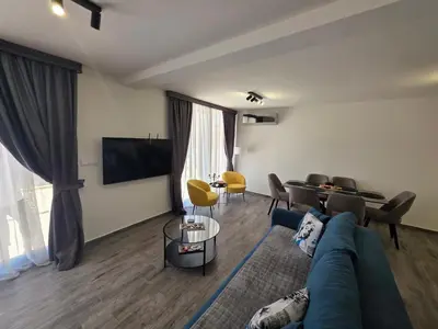 a living room with a blue couch and a table at Villa Azzurra in Radanovići