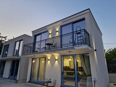a white house with a balcony and a patio at Villa Azzurra in Radanovići