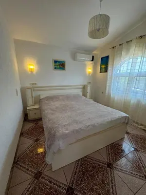 a bedroom with a large bed in a room at Apartments Sava in Dobra Voda