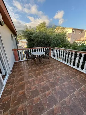 a patio with a table and chairs on a balcony at Apartments Sava in Dobra Voda