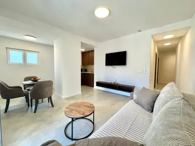 a living room with a couch and a table at Comfort Apartments Balkan in Budva