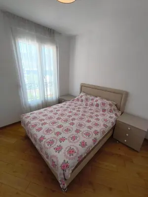 a bedroom with a bed with a flowered blanket at Sea view Chiron in Budva