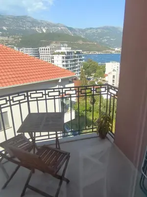 a balcony with a table and chairs on a building at Sea view Chiron in Budva