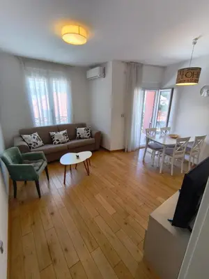 a living room with a couch and a table at Sea view Chiron in Budva