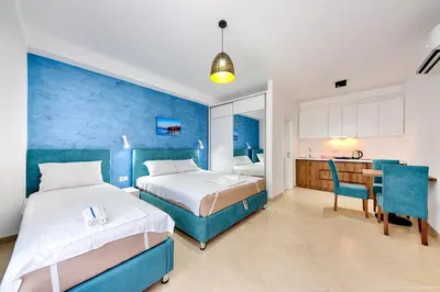 a hotel room with two beds and a desk at Lotos - apart 207 L1 in Dobra Voda