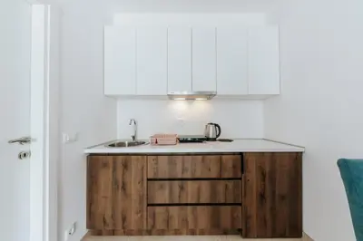 a kitchen with wooden cabinets and a sink at Lotos - apart 207 L1 in Dobra Voda