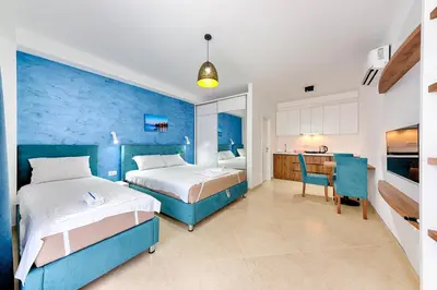 a hotel room with two beds and a kitchen at Lotos - apart 207 L1 in Dobra Voda