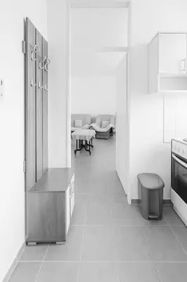 a kitchen with white walls and white floors at Apartman Ulcinj in Ulcinj
