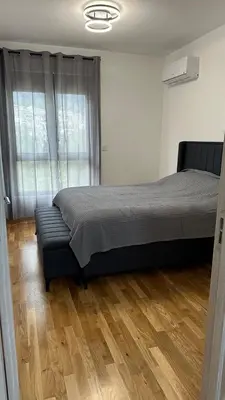 a bedroom with a bed and a couch in it at Comfort in Bar