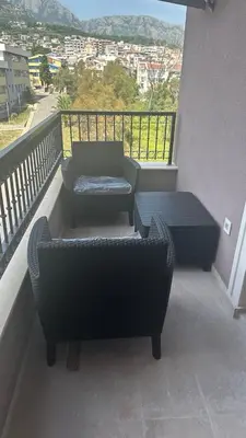 a balcony with a couch and a chair and a table at Comfort in Bar