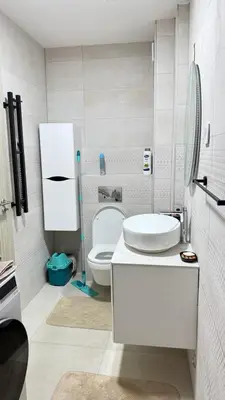 a white bathroom with a toilet and a sink at Comfort in Bar
