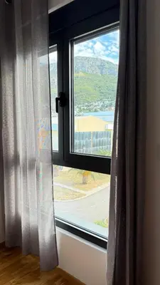 a large window with a view of a mountain at Comfort in Bar