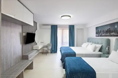 a hotel room with two beds and a tv at Residence Tommy in Budva