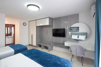 a hotel room with a bed and a flat screen tv at Residence Tommy in Budva