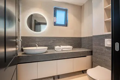 a bathroom with a sink and a mirror at Luxury Villa - New Building with pool and Fantastic Panoramic Sea View in Reževići