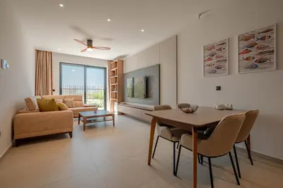 a living room with a table and a couch at Luxury Villa - New Building with pool and Fantastic Panoramic Sea View in Reževići