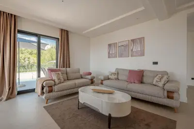 a living room with two couches and a coffee table at Luxury Villa - New Building with pool and Fantastic Panoramic Sea View in Reževići