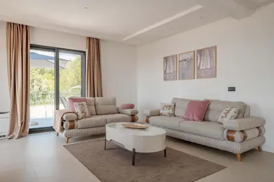 a living room with two couches and a coffee table at Luxury Villa - New Building with pool and Fantastic Panoramic Sea View in Reževići