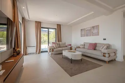 a living room with a couch and a table at Luxury Villa - New Building with pool and Fantastic Panoramic Sea View in Reževići