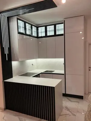 a kitchen with white cabinets and a black and white counter at Luxury Apartment With Sea View in Ulcinj