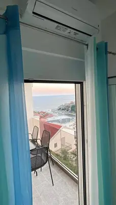 a balcony with a chair and a view of the ocean at Luxury Apartment With Sea View in Ulcinj
