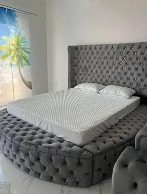 a bedroom with a large bed with a tufted mattress at Luxury Apartment With Sea View in Ulcinj
