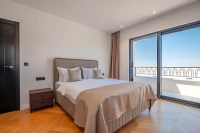 a bedroom with a large bed and a large window at Luxury Villa - New Building with pool and Fantastic Side Sea View in Budva